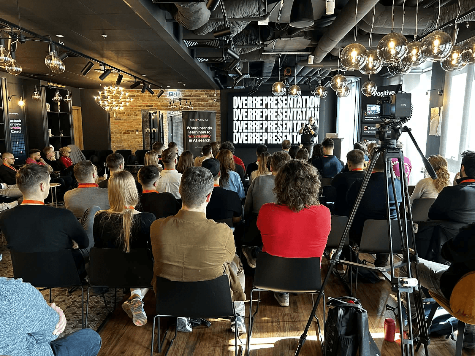 Jakub Sadowski speaking on AI visibility and overrepresentation